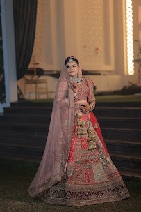 Full length Indian Bride in heavy pink/red Lehenga